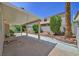 Covered patio and landscaped backyard offers an outdoor area for entertaining at 9746 Driftwood Island Ct, Las Vegas, NV 89148