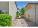 Side yard featuring a stone pathway and well-maintained landscaping at 9746 Driftwood Island Ct, Las Vegas, NV 89148