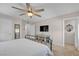 Comfortable bedroom with a ceiling fan, window and cabinet with glass doors at , Henderson, NV 89044