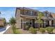 Side view of stucco-clad two-story home with desert landscaping and a walkway, under a blue sky at , Henderson, NV 89044