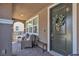 Inviting covered front porch with comfortable seating and a charming wreath on the front door at , Henderson, NV 89044
