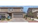 Charming townhome showcasing a well-manicured lawn and a spacious two-car garage at , Henderson, NV 89044