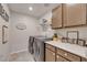 Laundry room including new washer and dryer, white counter tops, and storage space at , Henderson, NV 89044