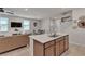 Open-concept living space with a modern kitchen island, a cozy fireplace, and ample natural light at , Henderson, NV 89044