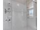Beautiful shower featuring white tile, glass door and built-in shelves at , Henderson, NV 89044