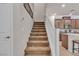 Carpeted staircase with a white railing leads to the upper level, conveniently near the kitchen at , Henderson, NV 89044