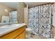 Traditional bathroom featuring shower, patterned curtain and tiled accent wall at , Las Vegas, NV 89145