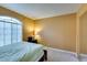 Relaxing carpeted bedroom with neutral walls, a large window, and a mirrored closet at , Las Vegas, NV 89145