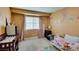 A cute, carpeted bedroom with a crib and twin bed adorned with wall decorations and curtains at , Las Vegas, NV 89145