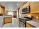 Open kitchen featuring a gas oven and cooktop, wood cabinets, and tile flooring at , Las Vegas, NV 89145