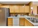 Bright kitchen with stainless steel refrigerator, stainless steel sink, and white dishwasher at , Las Vegas, NV 89145