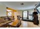 Living room featuring a fireplace, a large television, and exercise equipment by the window at , Las Vegas, NV 89145
