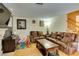 Spacious living room with warm tones featuring leather furniture and a staircase at , Las Vegas, NV 89145