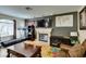 Well-lit living room featuring a fireplace, television, exercise equipment, and leather furniture at , Las Vegas, NV 89145