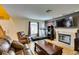 Cozy living room with a fireplace, large television, exercise equipment, and comfortable leather seating at , Las Vegas, NV 89145