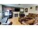 Comfortable living room with a fireplace, television, wood floors, and a leather sofa set at , Las Vegas, NV 89145