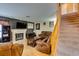 Inviting living room with a cozy fireplace, wood floors, and staircase to the second level at , Las Vegas, NV 89145