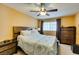 Comfortable main bedroom featuring a ceiling fan, large window, and two dressers at , Las Vegas, NV 89145