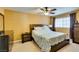A carpeted main bedroom featuring a ceiling fan, large window, and two dressers at , Las Vegas, NV 89145