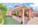 Spacious backyard with pavers, artificial turf, and a covered patio, ideal for outdoor activities and relaxation at 10247 Jamapa Dr, Las Vegas, NV 89178