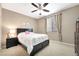 Comfortable bedroom with carpet, a ceiling fan, and a window, creating a cozy and well-lit space at 10247 Jamapa Dr, Las Vegas, NV 89178