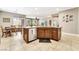 Open concept kitchen with island, stainless appliances, and adjacent dining area at 10247 Jamapa Dr, Las Vegas, NV 89178