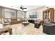 Spacious living room with laminate wood flooring, neutral walls, and recessed lighting at 10247 Jamapa Dr, Las Vegas, NV 89178