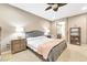 Main bedroom with en-suite bathroom featuring tiled floors and a ceiling fan at 10247 Jamapa Dr, Las Vegas, NV 89178