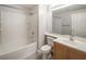 Bright bathroom featuring a shower-tub combination with white tile and a vanity with wood finish at 10291 Delta View Ct # 101, Las Vegas, NV 89129
