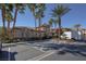 Community building exterior featuring desert landscaping, shade trees, and ample parking for visitors at 10291 Delta View Ct # 101, Las Vegas, NV 89129