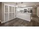 Bright kitchen with white cabinets, stainless steel appliances, quartz countertops, and hardwood floors at 10291 Delta View Ct # 101, Las Vegas, NV 89129