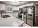 Modern kitchen featuring stainless steel appliances, quartz countertops, and ample cabinet space at 10291 Delta View Ct # 101, Las Vegas, NV 89129