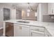 Stylish kitchen showcasing quartz countertops, stainless steel appliances, and an open view to the living area at 10291 Delta View Ct # 101, Las Vegas, NV 89129