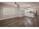 Open-concept living room with dark wood floors, ceiling fan, and easy access to kitchen with stainless appliances at 10291 Delta View Ct # 101, Las Vegas, NV 89129