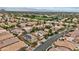 Aerial view showcases a neighborhood with the home amongst other houses, mountains in the distance at 10680 Sapphire Vista Ave, Las Vegas, NV 89144