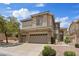 Inviting two-story home featuring a three car garage and manicured landscaping with a beautiful stone facade at 10680 Sapphire Vista Ave, Las Vegas, NV 89144