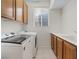 Bright laundry room equipped with washer, dryer, and sink at 10680 Sapphire Vista Ave, Las Vegas, NV 89144