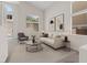 Bright and airy living room featuring high ceilings, modern decor, and views of the sparkling backyard pool at 10680 Sapphire Vista Ave, Las Vegas, NV 89144