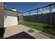Landscaped backyard featuring a well-maintained artificial lawn and play area with a swing set at 109 Ash St, Henderson, NV 89015