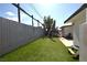 Inviting backyard with artificial turf, a mature shade tree, and a picnic table at 109 Ash St, Henderson, NV 89015