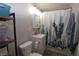 Compact bathroom featuring a vanity, toilet, and shower with a whimsical cactus curtain at 109 Ash St, Henderson, NV 89015