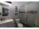Well-lit bathroom with a modern vanity, toilet, and glass-enclosed shower for a refreshing experience at 109 Ash St, Henderson, NV 89015