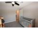Comfortable bedroom space with a crib, ceiling fan, and neutral colors, perfect for relaxation at 109 Ash St, Henderson, NV 89015