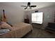 Cozy bedroom featuring a ceiling fan, guitar, and desk area by the bright window at 109 Ash St, Henderson, NV 89015