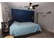 Comfortable bedroom with plush carpet, a blue accent wall, and a ceiling fan for added air circulation at 109 Ash St, Henderson, NV 89015