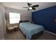 Serene bedroom featuring a comfortable bed, ample natural light, and a ceiling fan at 109 Ash St, Henderson, NV 89015