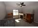 Spacious bedroom with a crib, a bunk bed, and a sunlit window, creating a versatile living space at 109 Ash St, Henderson, NV 89015