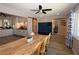 An open dining area shows dark laminate wood floors, a sliding barn door, and a kitchen in background at 109 Ash St, Henderson, NV 89015