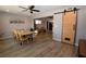 Dining room featuring light colored wooden floors and a sliding barn door at 109 Ash St, Henderson, NV 89015