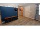 Beautiful foyer with durable laminate wood floors and a contemporary dark blue accent wall at 109 Ash St, Henderson, NV 89015